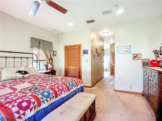 a bedroom with a bed and a lamp