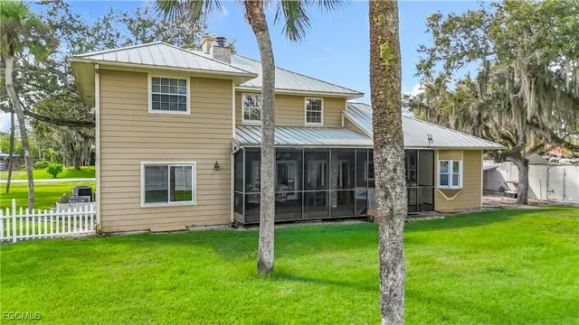 a large tree in a yard next to a large tree