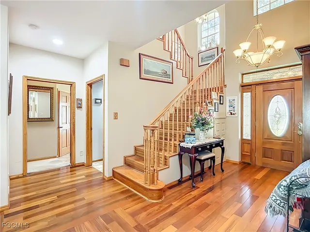 a view of an entryway with wooden floor and door