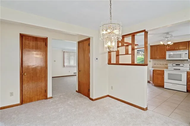 a view of a kitchen with stainless steel appliances granite countertop a stove and a refrigerator