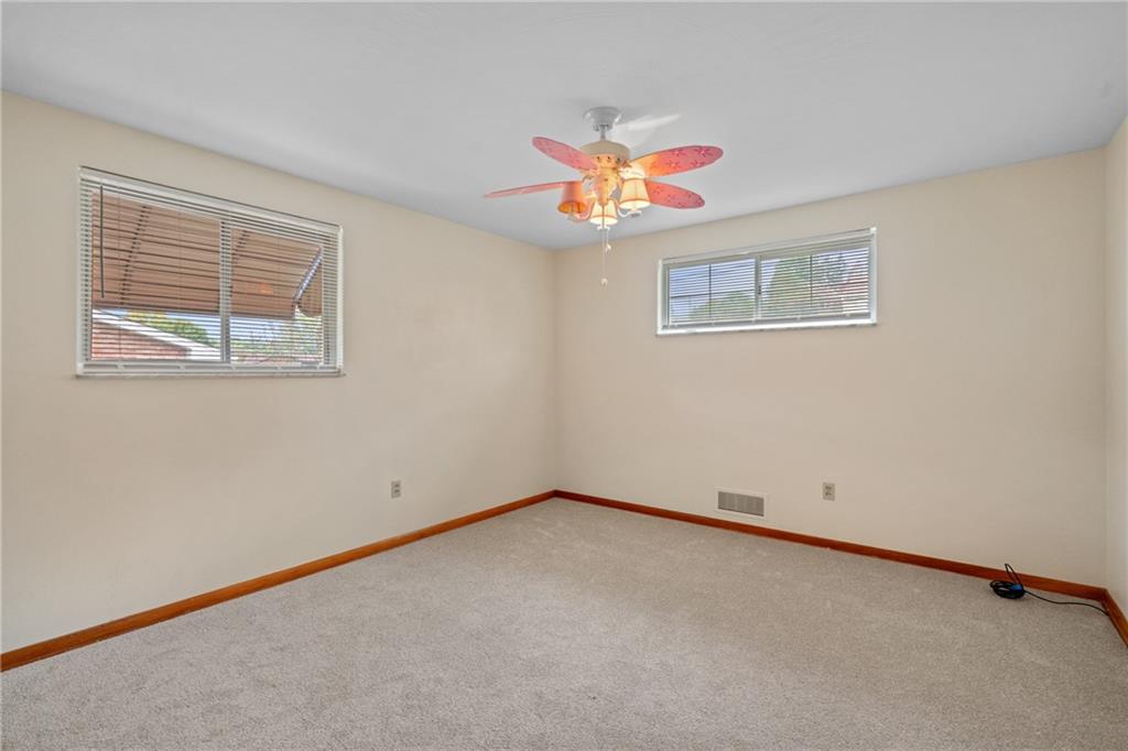 11490 McKee Road Irwin, PA 15642 - Photo 18 of 28 an empty room with a window and a fan