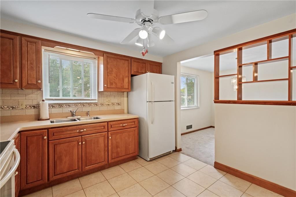 11490 McKee Road Irwin, PA 15642 - Photo 7 of 28 a kitchen with stainless steel appliances a refrigerator sink and cabinets