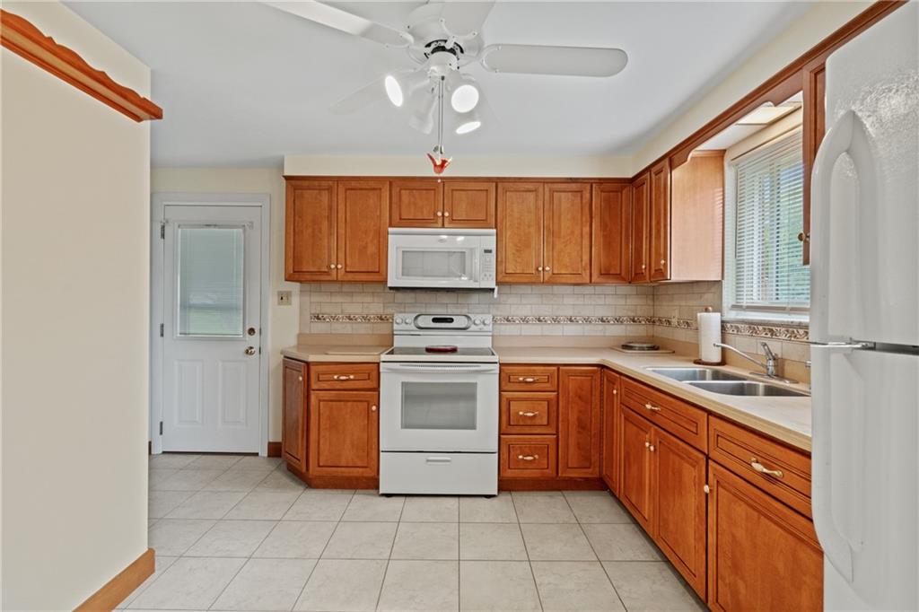 11490 McKee Road Irwin, PA 15642 - Photo 8 of 28 a kitchen with stainless steel appliances granite countertop a stove sink and cabinets