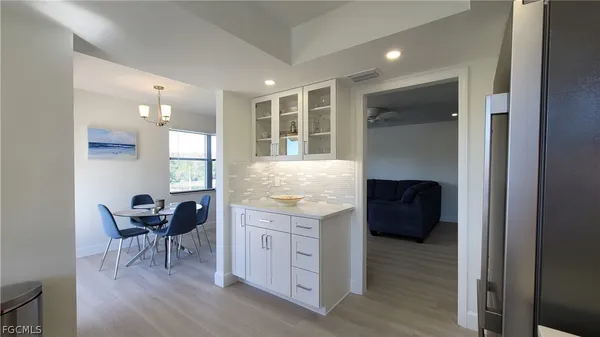 a view of a kitchen with furniture and wooden floor