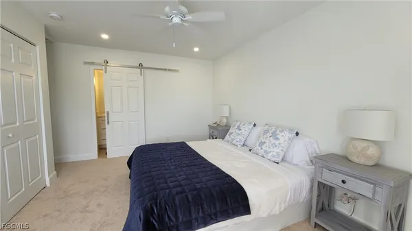 a spacious bedroom with a bed and a window
