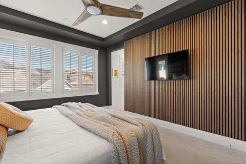 a bedroom with a bed and a flat screen tv