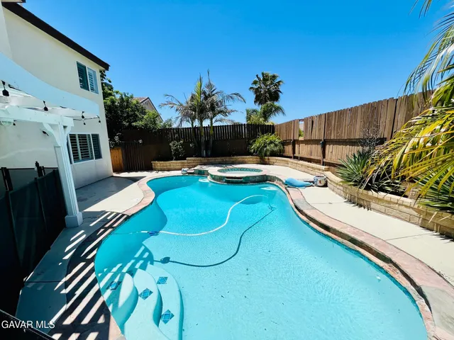 a view of backyard with furniture and a bench