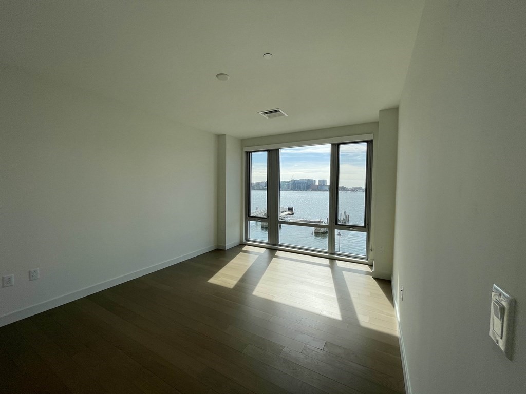 45 Lewis Street, Unit 310 Boston, MA 02128 - Photo 4 of 11 an empty room with windows