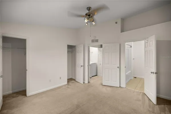an empty room with fan and entrance