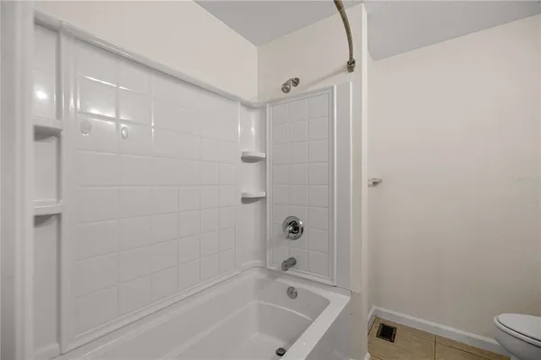 a bathroom with a bathtub and toilet