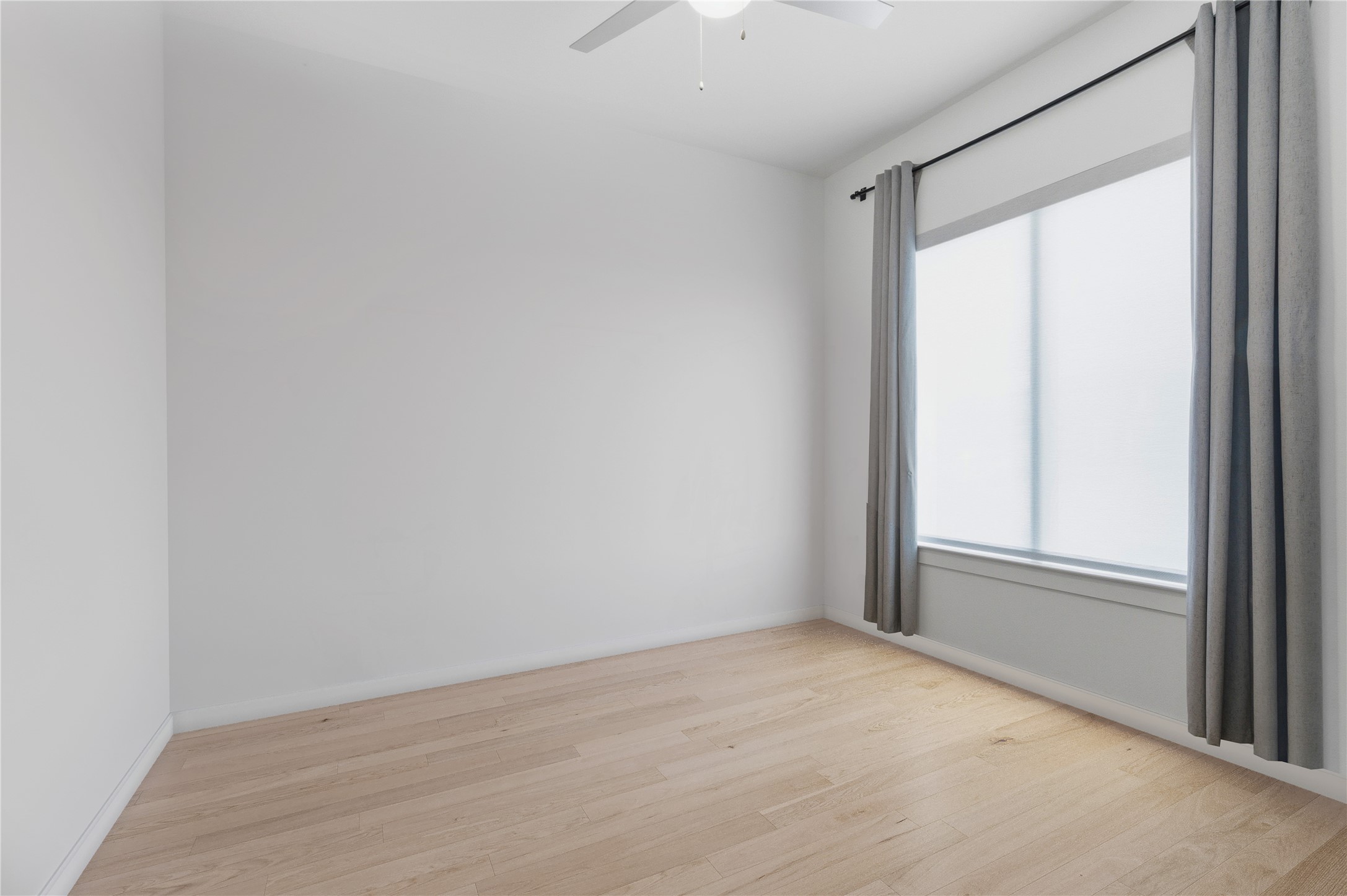 14108 Redfish Lake Conroe, TX 77384 - Photo 13 of 37 an empty room with wooden floor and windows