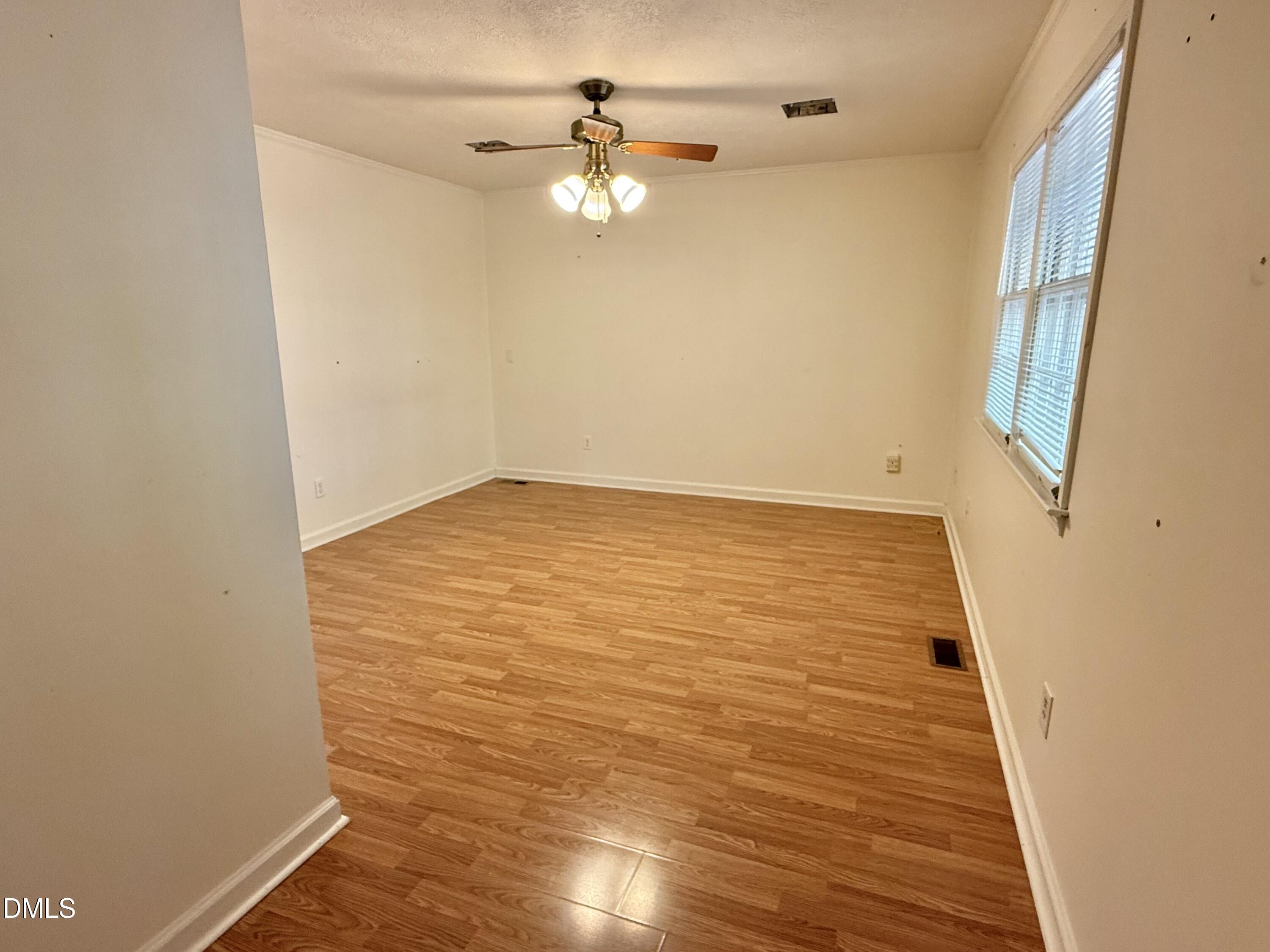 2320 Poindexter Road Hurdle Mills, NC 27541 - Photo 12 of 57 wooden floor in an empty room with a window