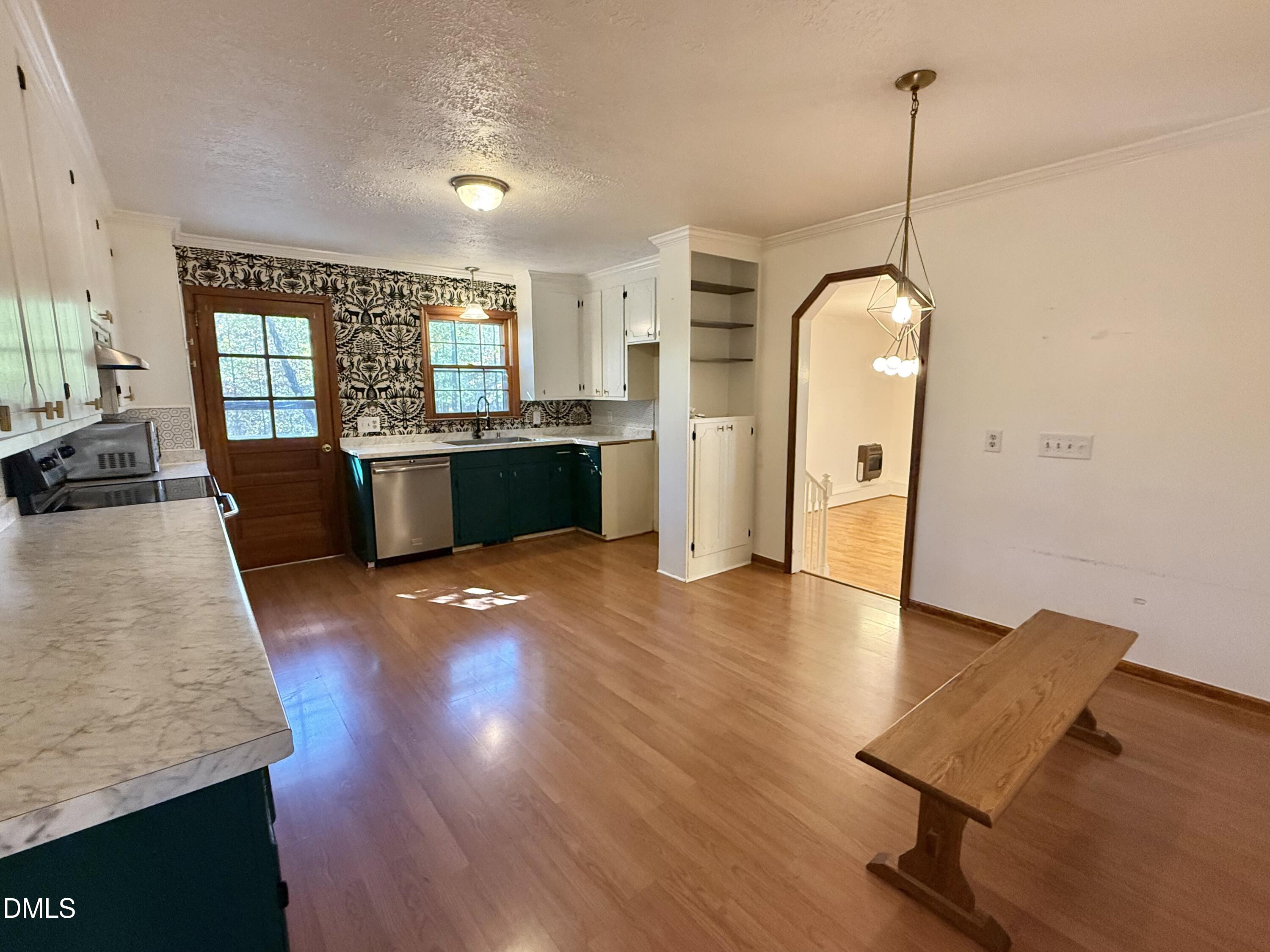 2320 Poindexter Road Hurdle Mills, NC 27541 - Photo 15 of 57 a view of a living room and kitchen with a wooden floor