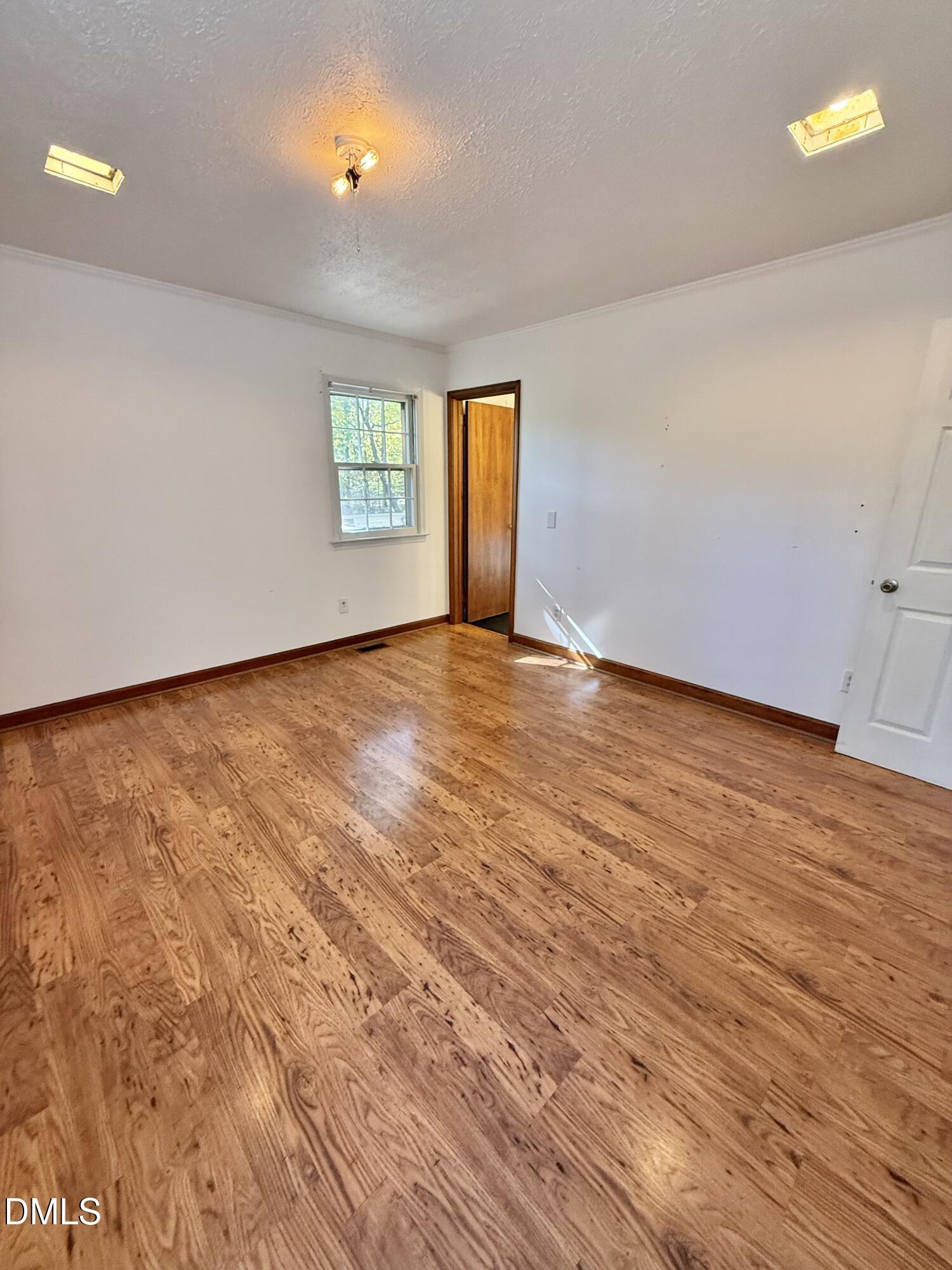 2320 Poindexter Road Hurdle Mills, NC 27541 - Photo 21 of 57 a view of an empty room with window and wooden floor
