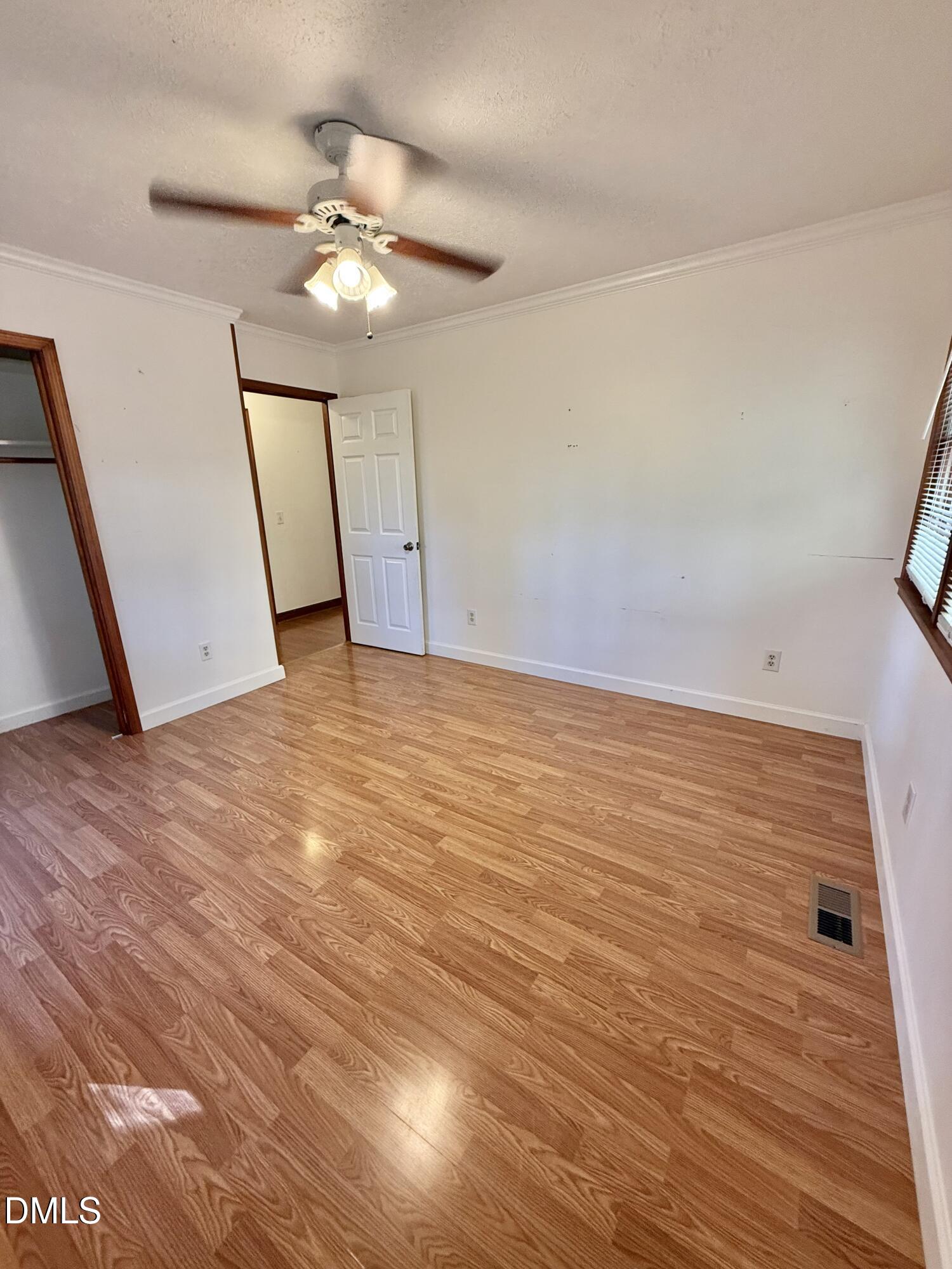 2320 Poindexter Road Hurdle Mills, NC 27541 - Photo 25 of 57 a view of an empty room with wooden floor and a ceiling fan