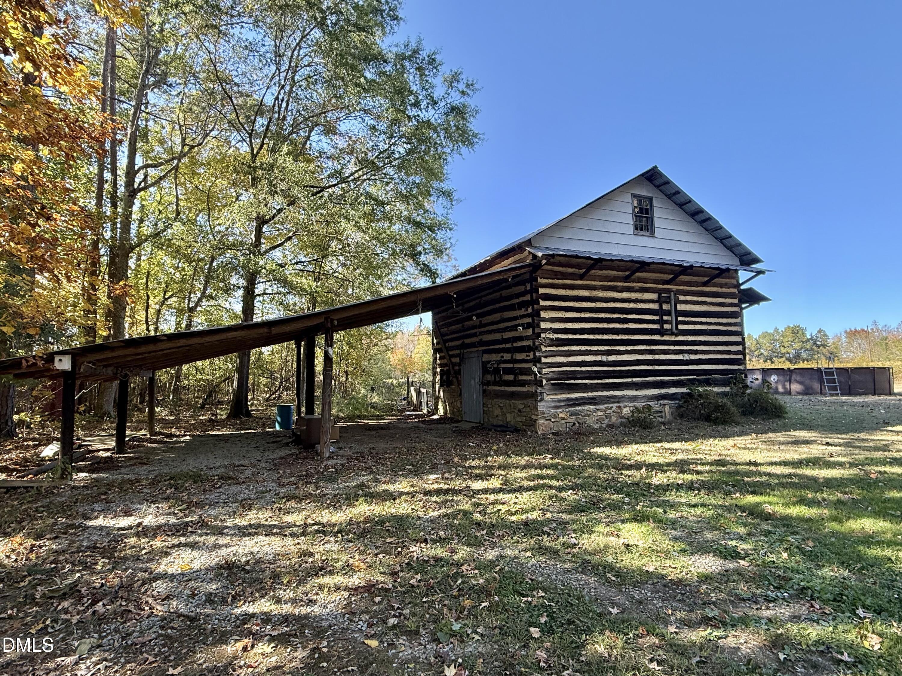 2320 Poindexter Road Hurdle Mills, NC 27541 - Photo 40 of 57 a view of a house with a yard