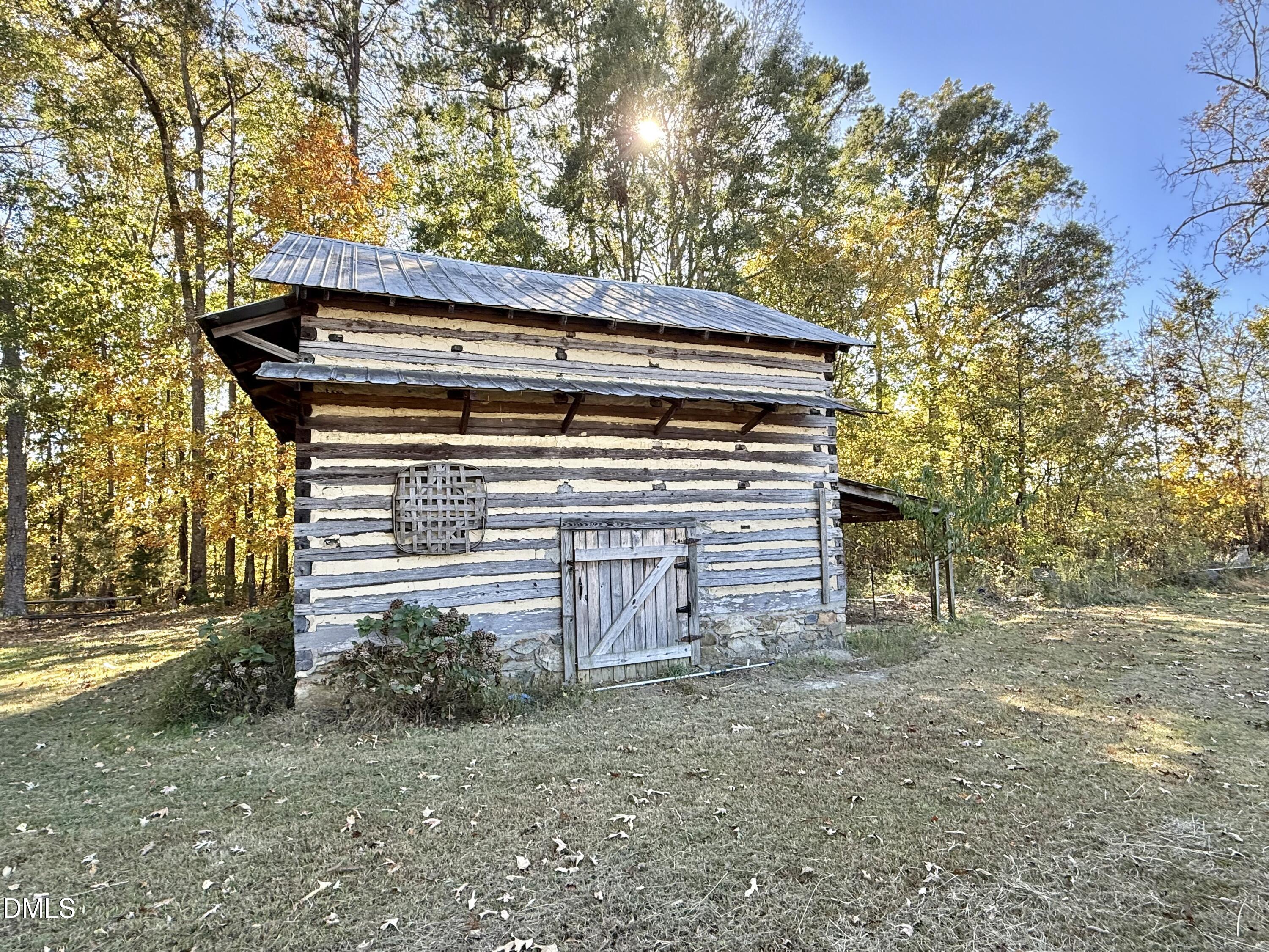 2320 Poindexter Road Hurdle Mills, NC 27541 - Photo 43 of 57 a view of a house with a yard