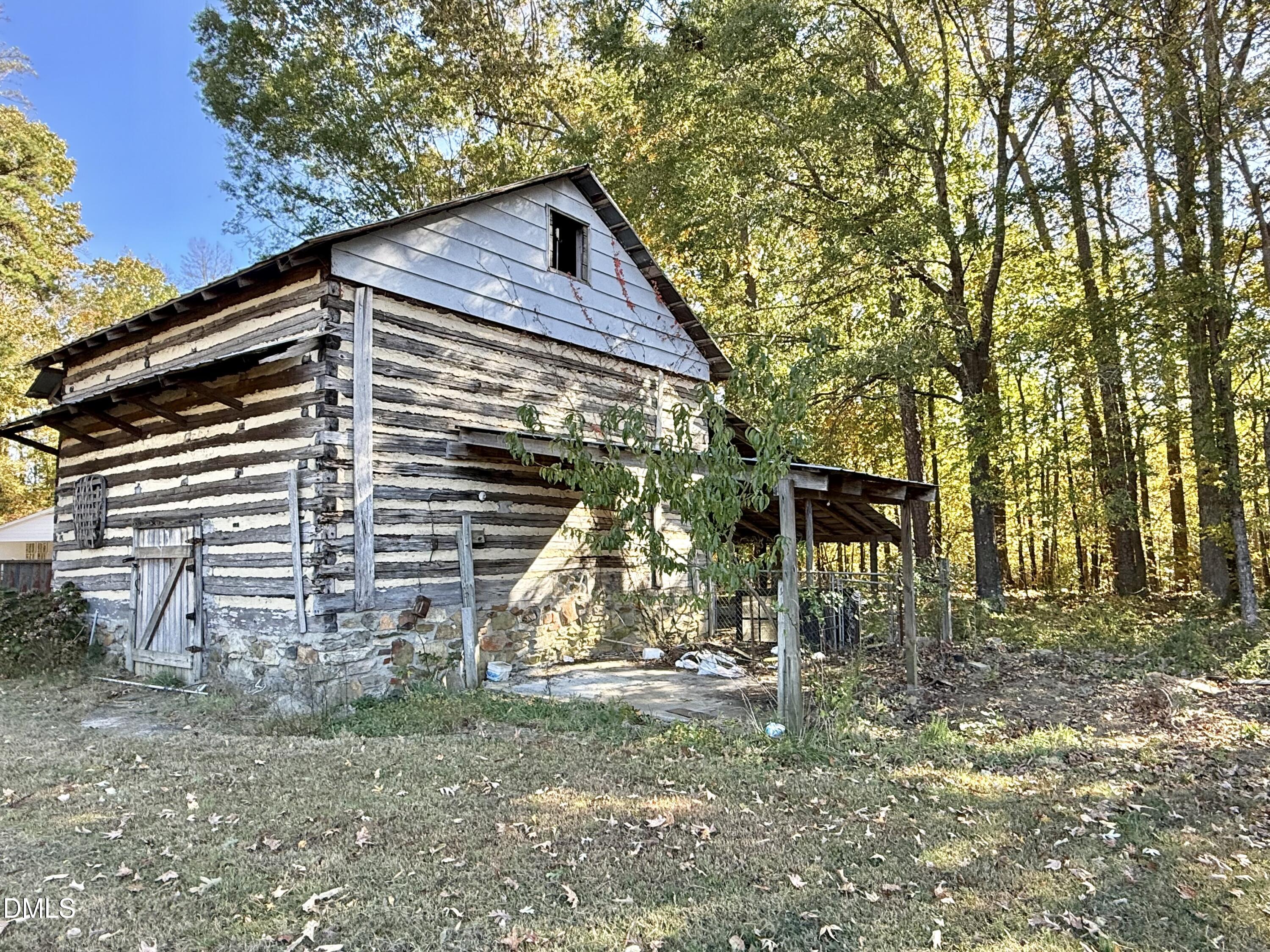 2320 Poindexter Road Hurdle Mills, NC 27541 - Photo 44 of 57 a backyard of a house with table and chairs