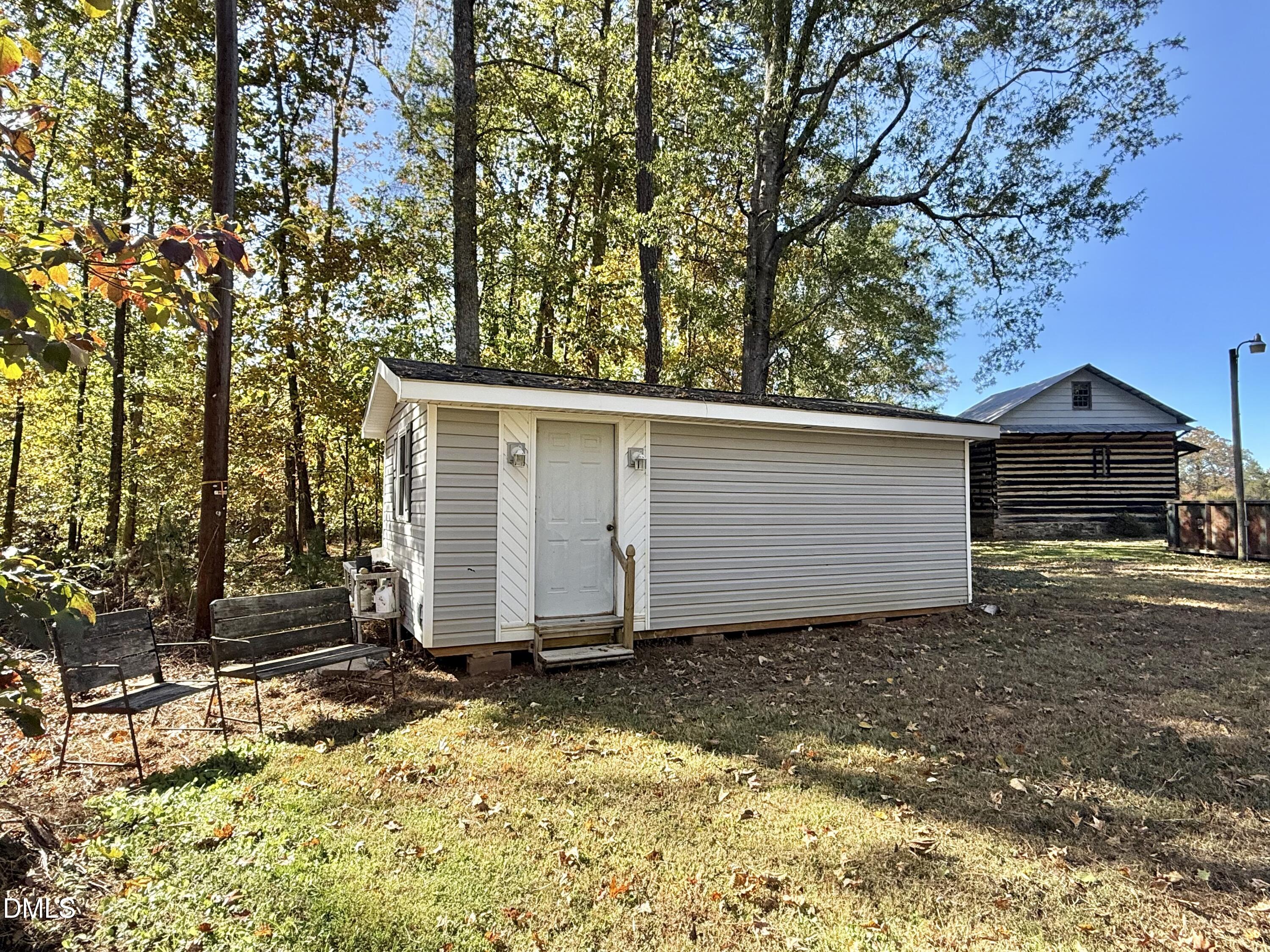 2320 Poindexter Road Hurdle Mills, NC 27541 - Photo 49 of 57 a view of a house with a yard