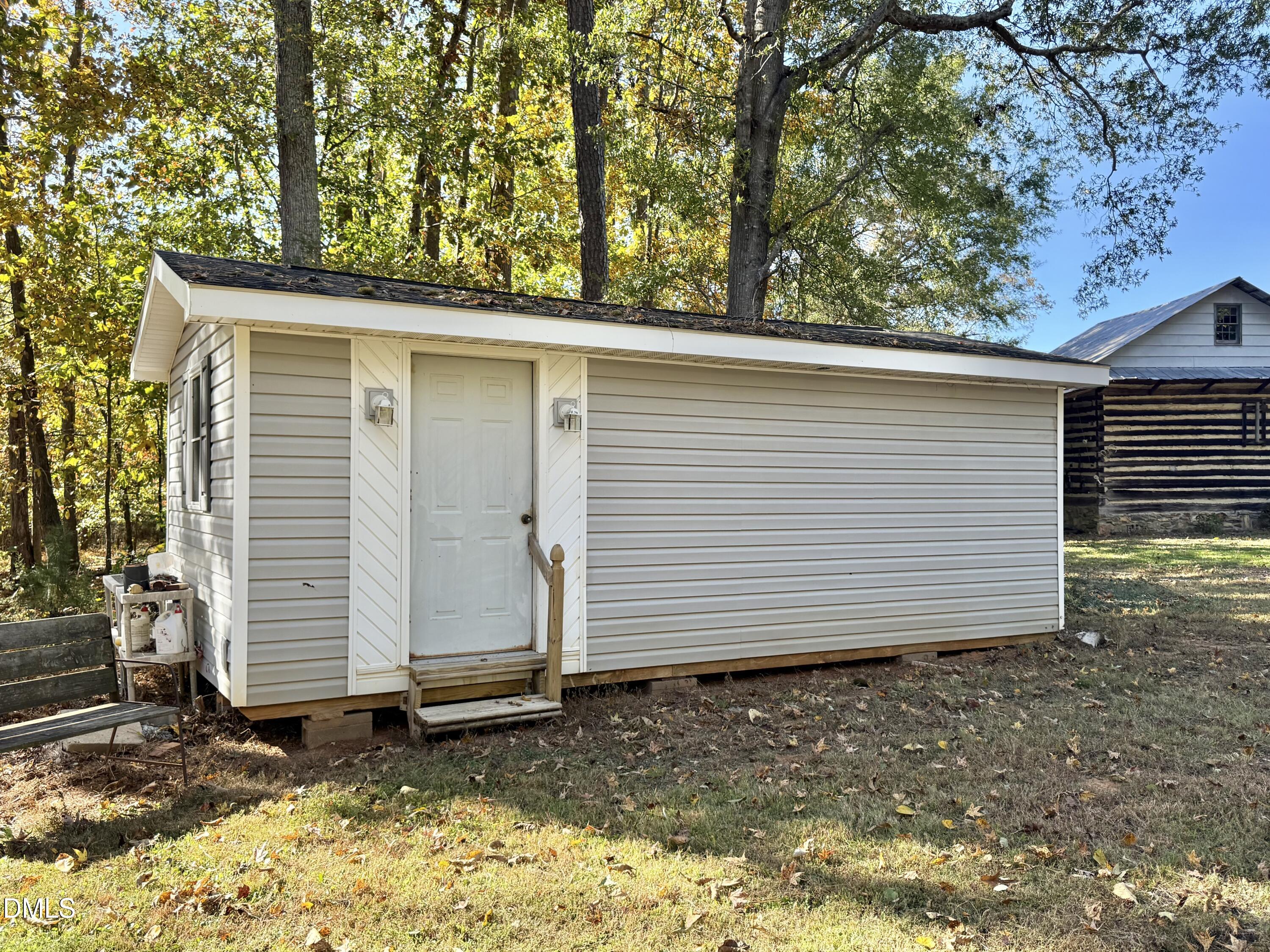 2320 Poindexter Road Hurdle Mills, NC 27541 - Photo 50 of 57 a view of a house with a yard