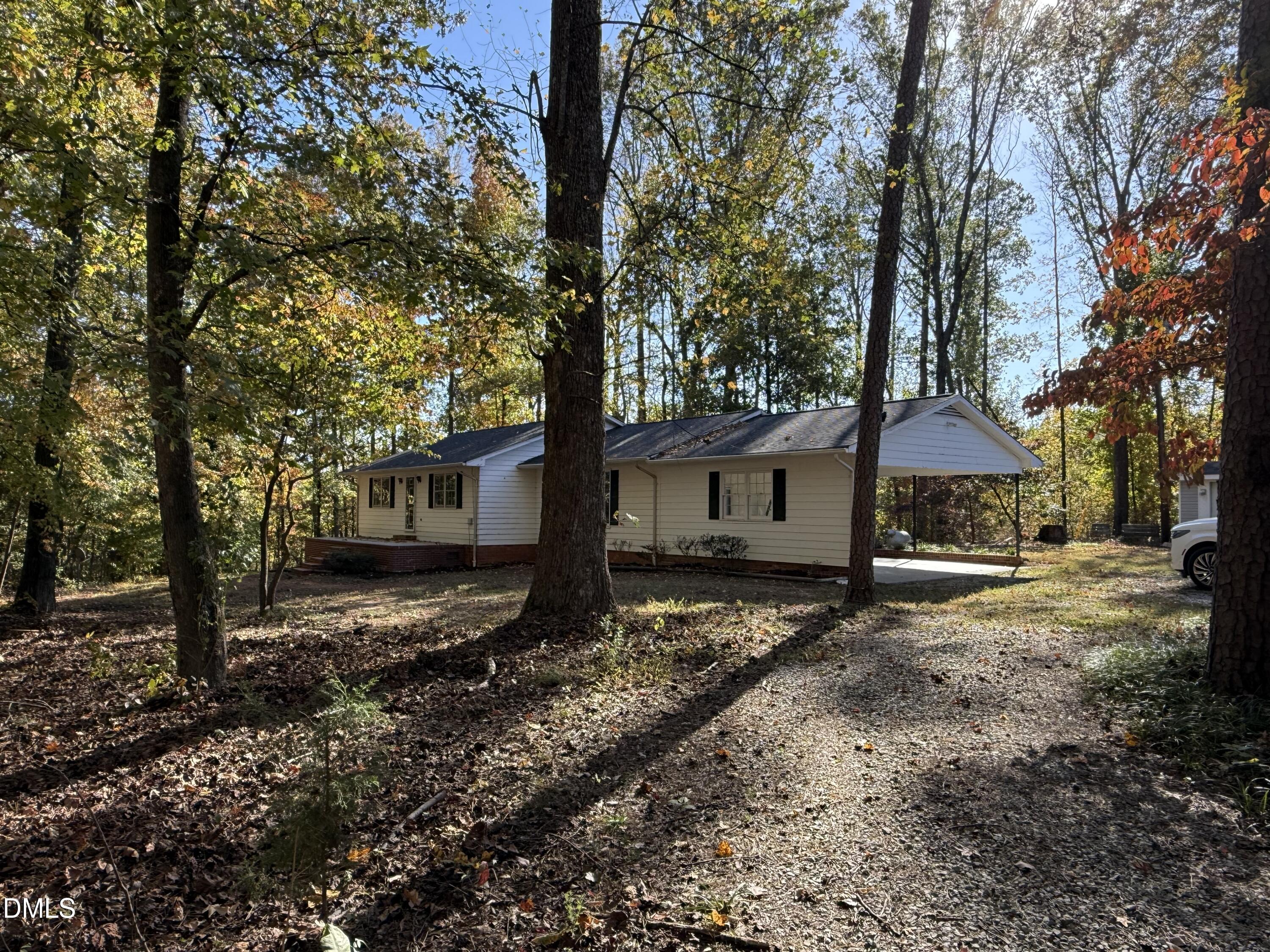 2320 Poindexter Road Hurdle Mills, NC 27541 - Photo 55 of 57 a backyard of a house with wooden fence and large trees