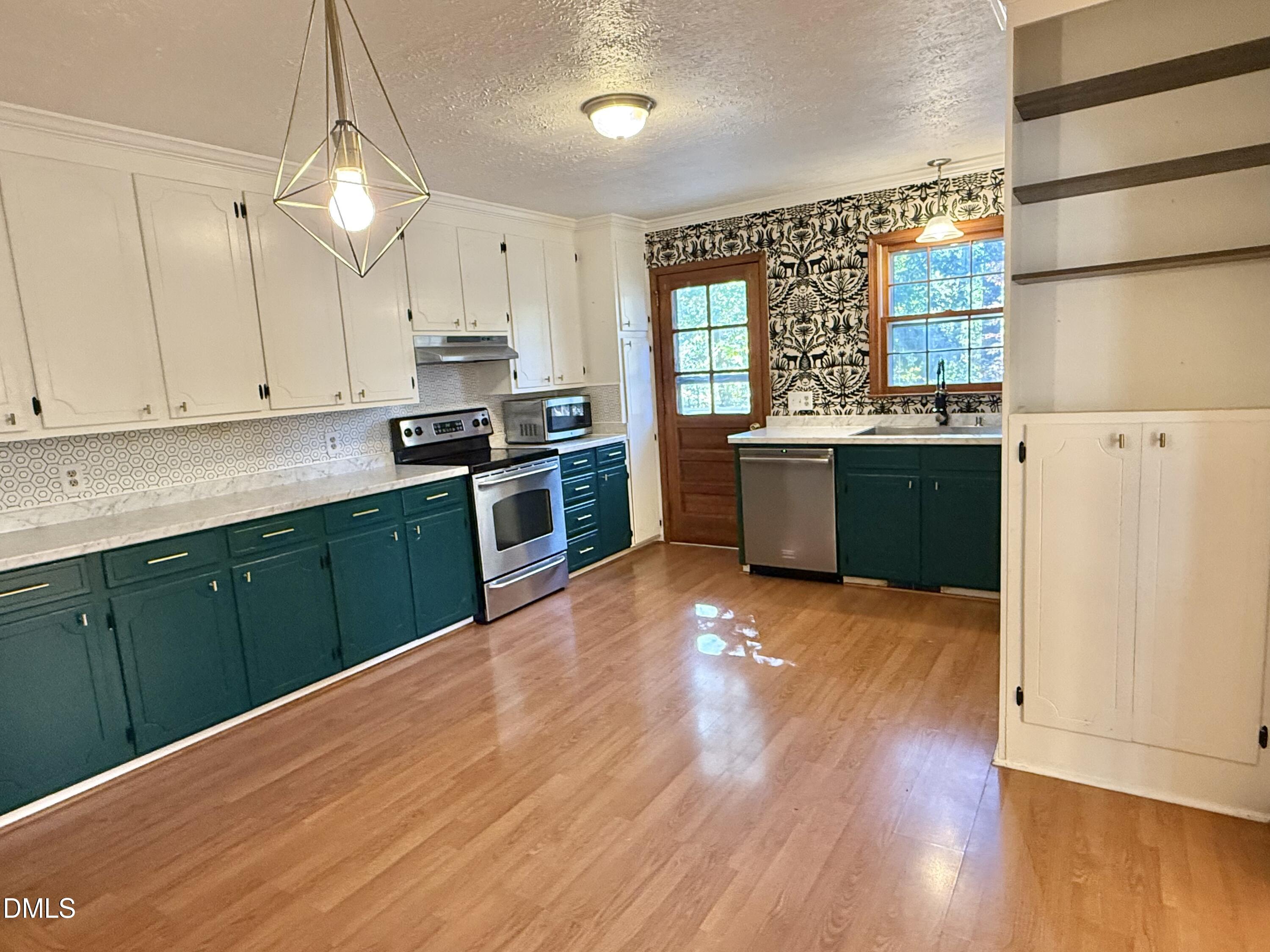 2320 Poindexter Road Hurdle Mills, NC 27541 - Photo 7 of 57 a kitchen with stainless steel appliances granite countertop a stove a sink dishwasher and a refrigerator with wooden floor