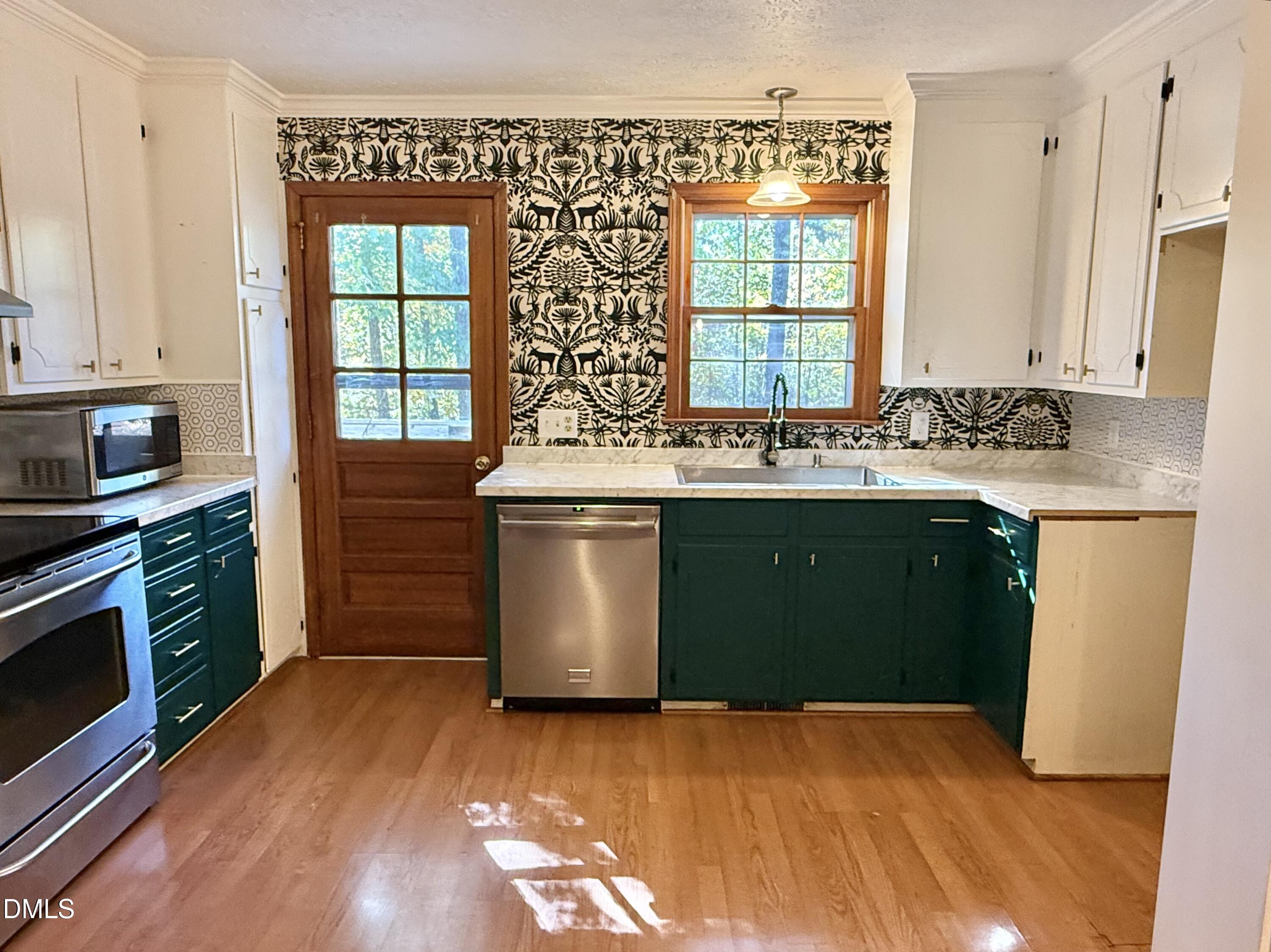 2320 Poindexter Road Hurdle Mills, NC 27541 - Photo 8 of 57 a kitchen with stainless steel appliances granite countertop a stove a sink and a microwave