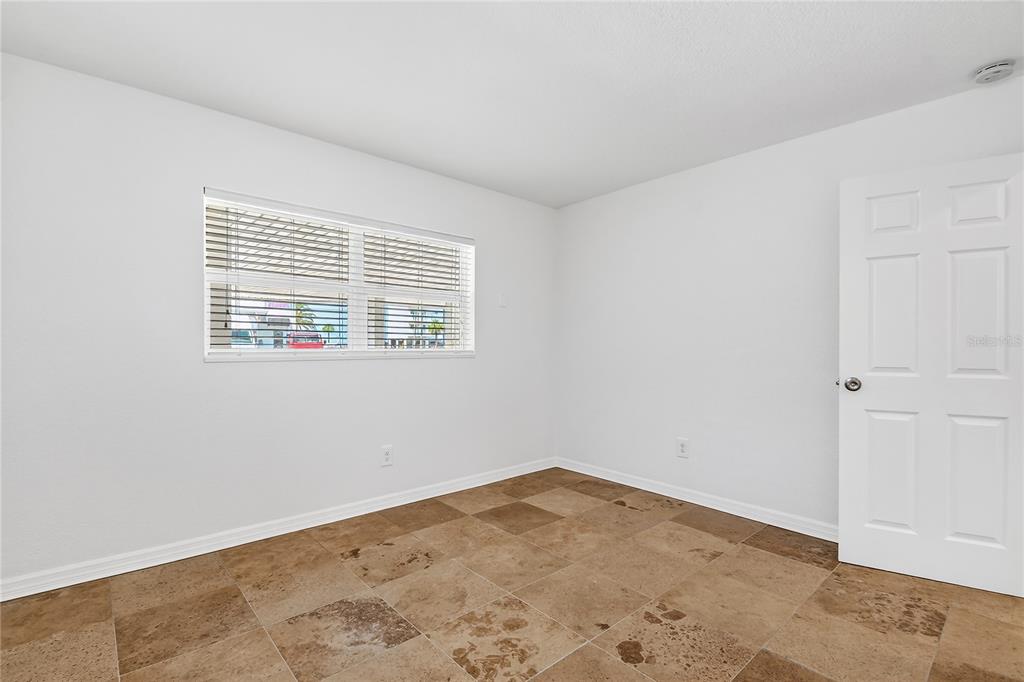 13440 1st Street East Madeira Beach, FL 33708 - Photo 22 of 44 an empty room with a window