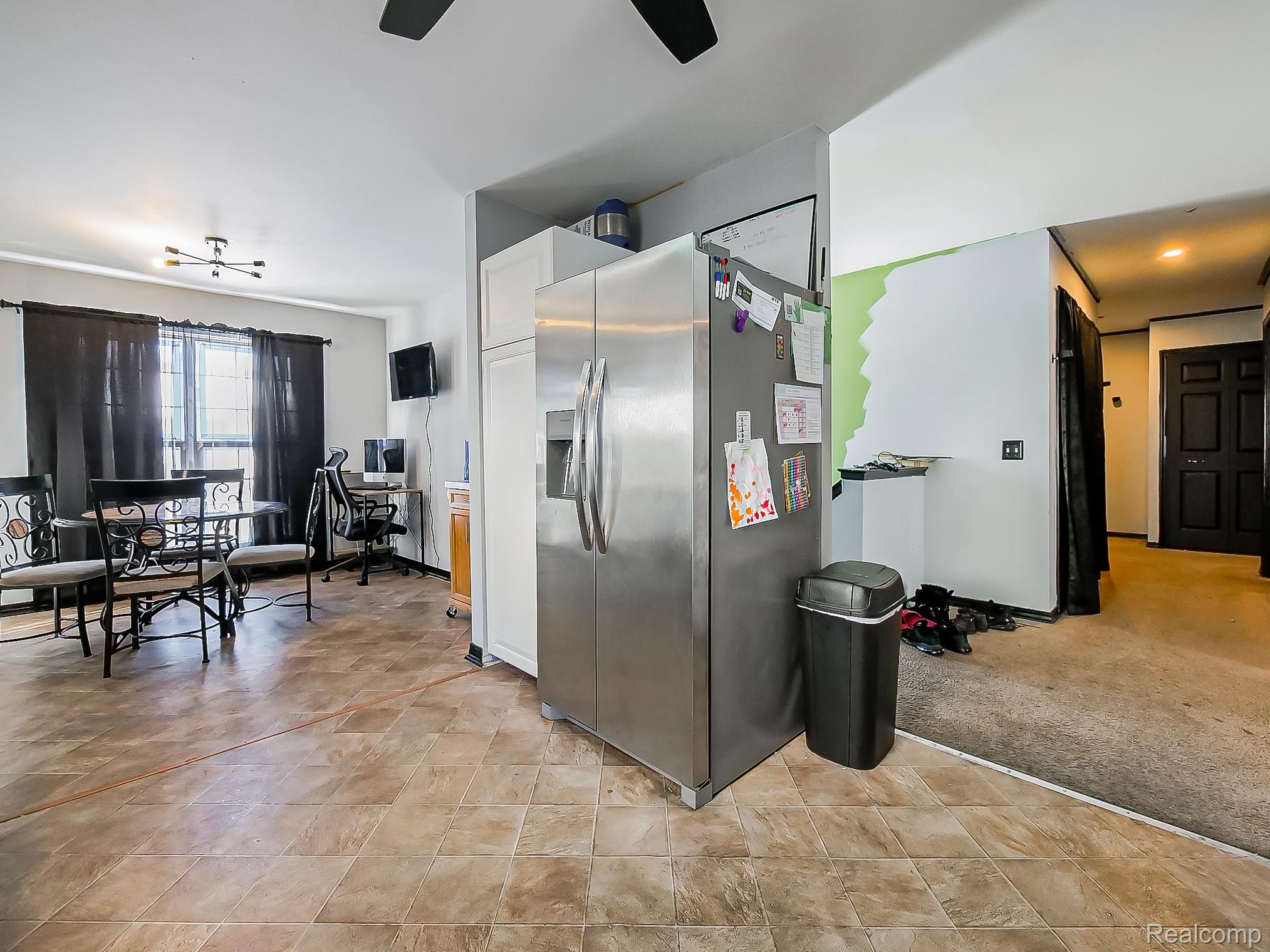 34460 Van Born Road Wayne, MI 48184 - Photo 6 of 31 Kitchen with stainless steel fridge, a desk, a ceiling fan, and light colored carpet