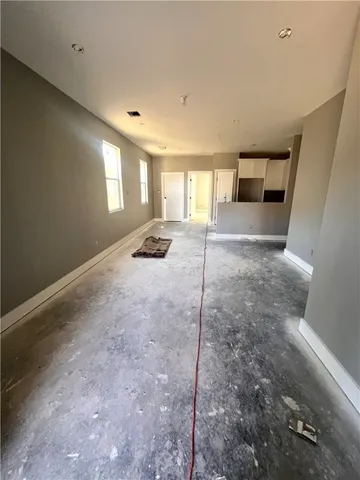 a view of a room with window and hardwood floor
