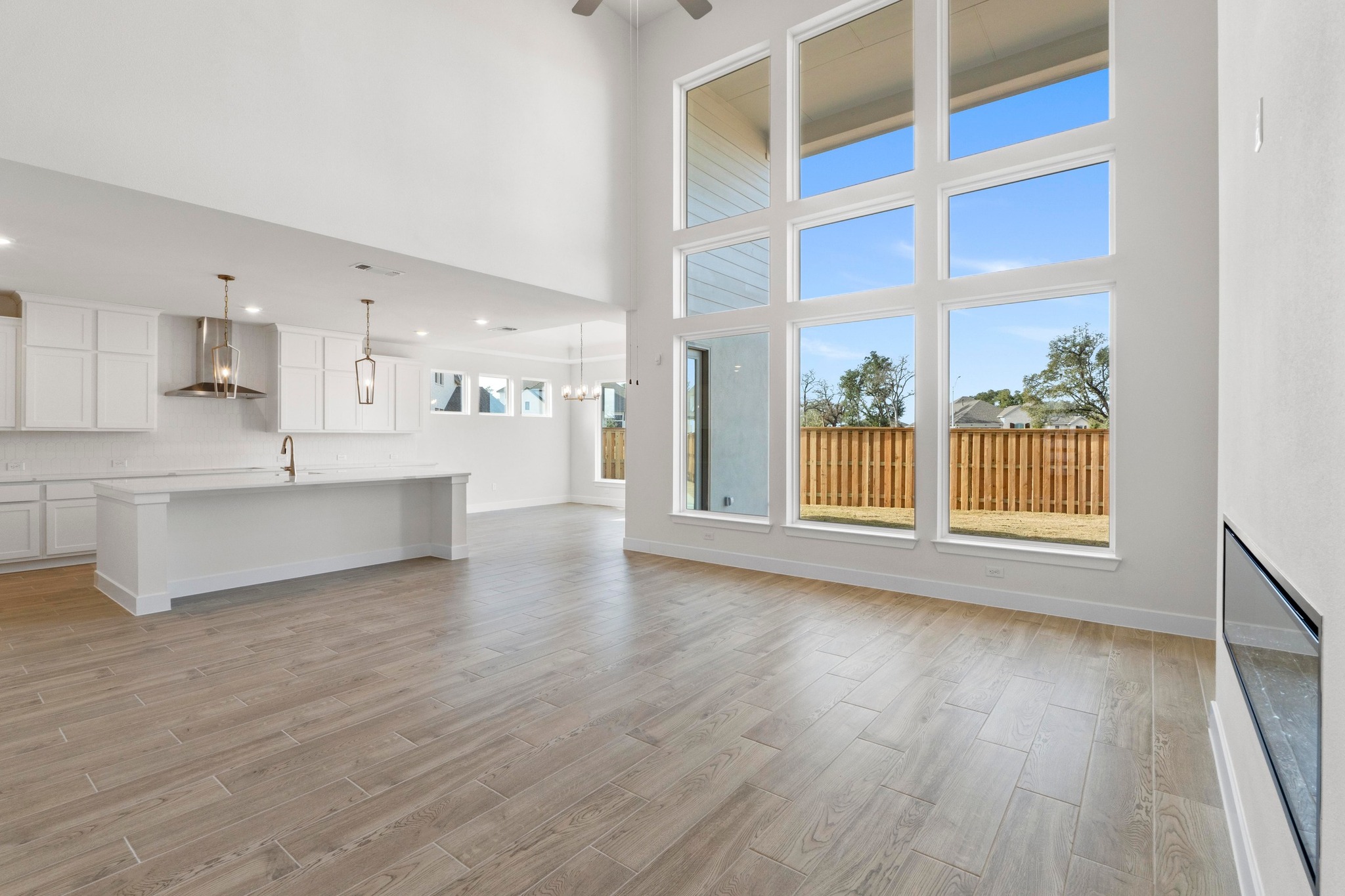 604 Lightstone Drive Georgetown, TX 78633 - Photo 9 of 39 a view of an empty room with a window and wooden floor