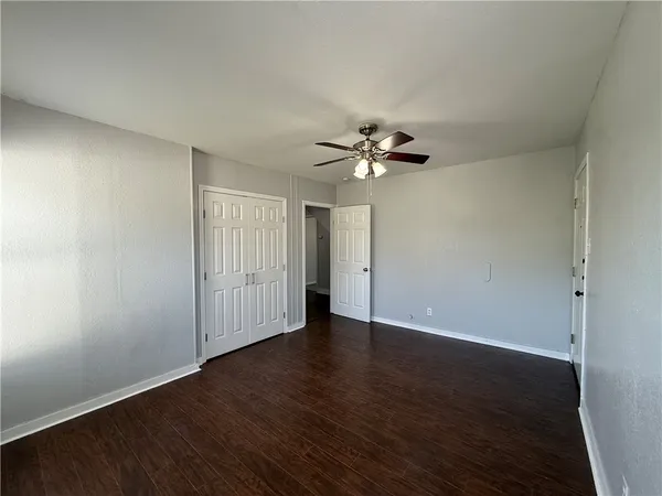 a view of an empty room with wooden floor