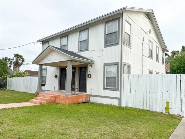 a view of a house with a yard and porch