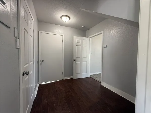 a view of hallway with wooden floor