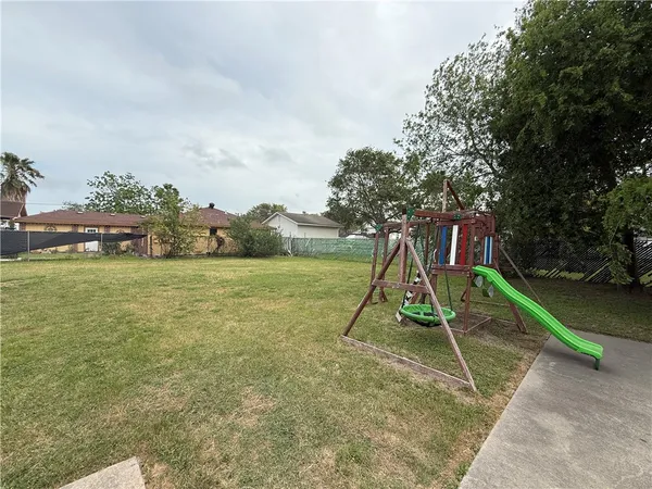 a view of outdoor space with playground and green space