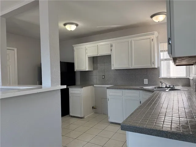 a kitchen with a sink cabinets and window