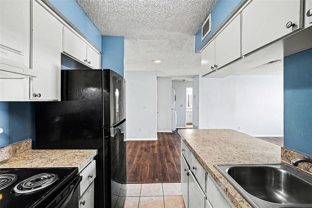 550 Golden Raintree Place, Unit 550 Brandon, FL 33510 - Photo 14 of 33 a kitchen with a stove and a refrigerator
