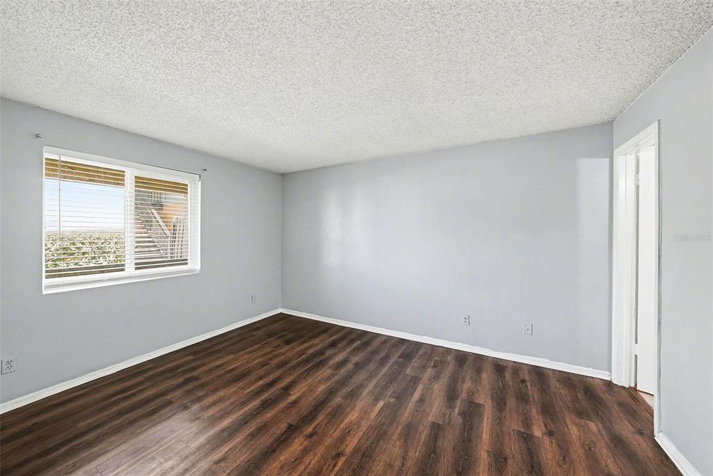 550 Golden Raintree Place, Unit 550 Brandon, FL 33510 - Photo 16 of 33 a view of an empty room with wooden floor and a window