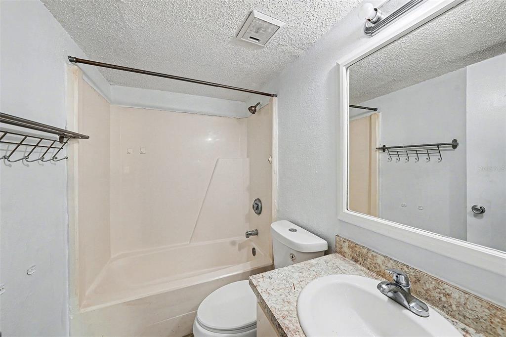 550 Golden Raintree Place, Unit 550 Brandon, FL 33510 - Photo 17 of 33 a bathroom with a granite countertop sink toilet and shower