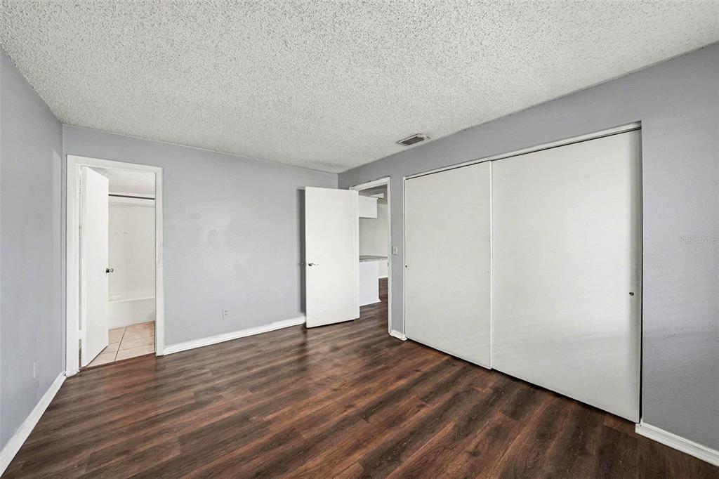 550 Golden Raintree Place, Unit 550 Brandon, FL 33510 - Photo 19 of 33 a view of an empty room with wooden floor and a window