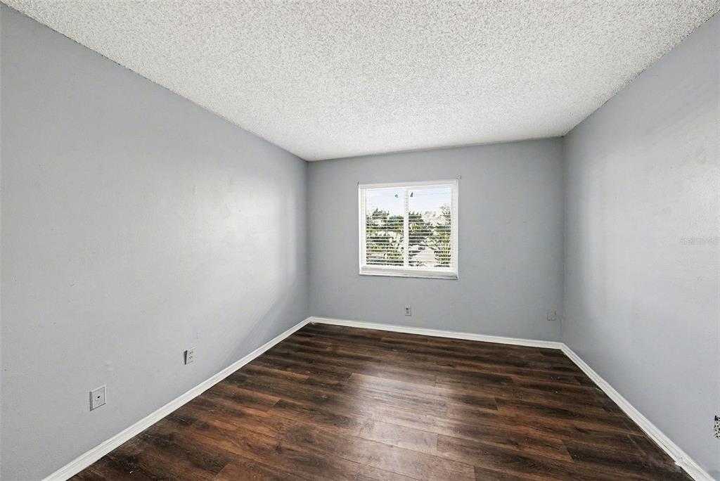 550 Golden Raintree Place, Unit 550 Brandon, FL 33510 - Photo 21 of 33 wooden floor in an empty room with a window