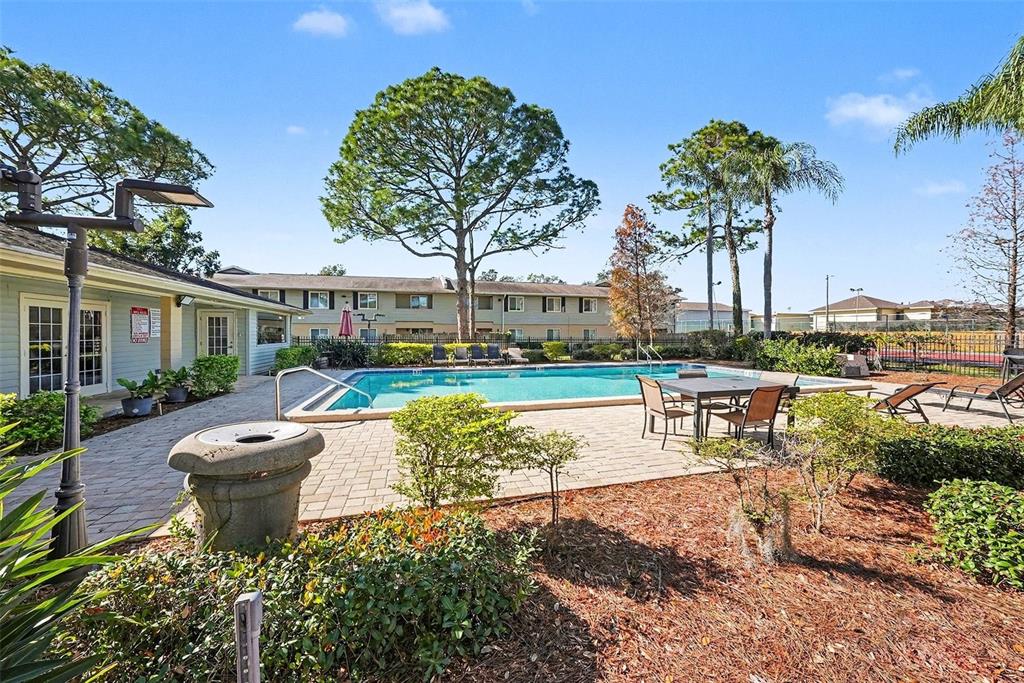 550 Golden Raintree Place, Unit 550 Brandon, FL 33510 - Photo 23 of 33 a swimming pool with outdoor seating and yard