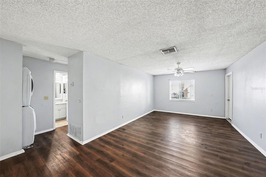 550 Golden Raintree Place, Unit 550 Brandon, FL 33510 - Photo 6 of 33 an empty room with wooden floor and windows