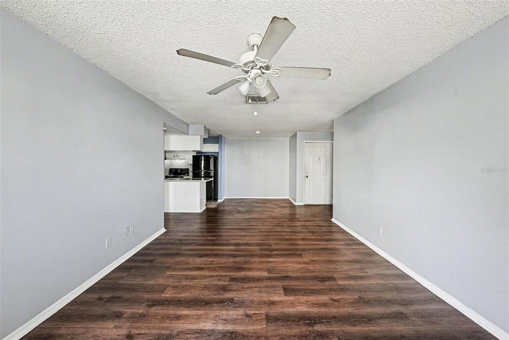 550 Golden Raintree Place, Unit 550 Brandon, FL 33510 - Photo 9 of 33 a view of an empty room with window and wooden floor
