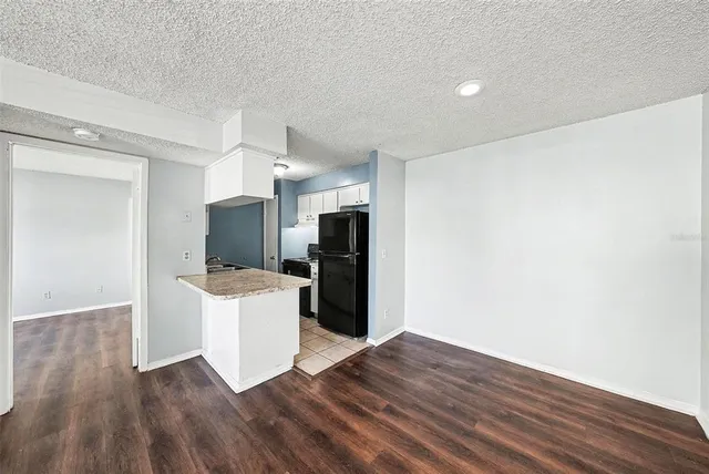 a view of a kitchen with a sink and a refrigerator