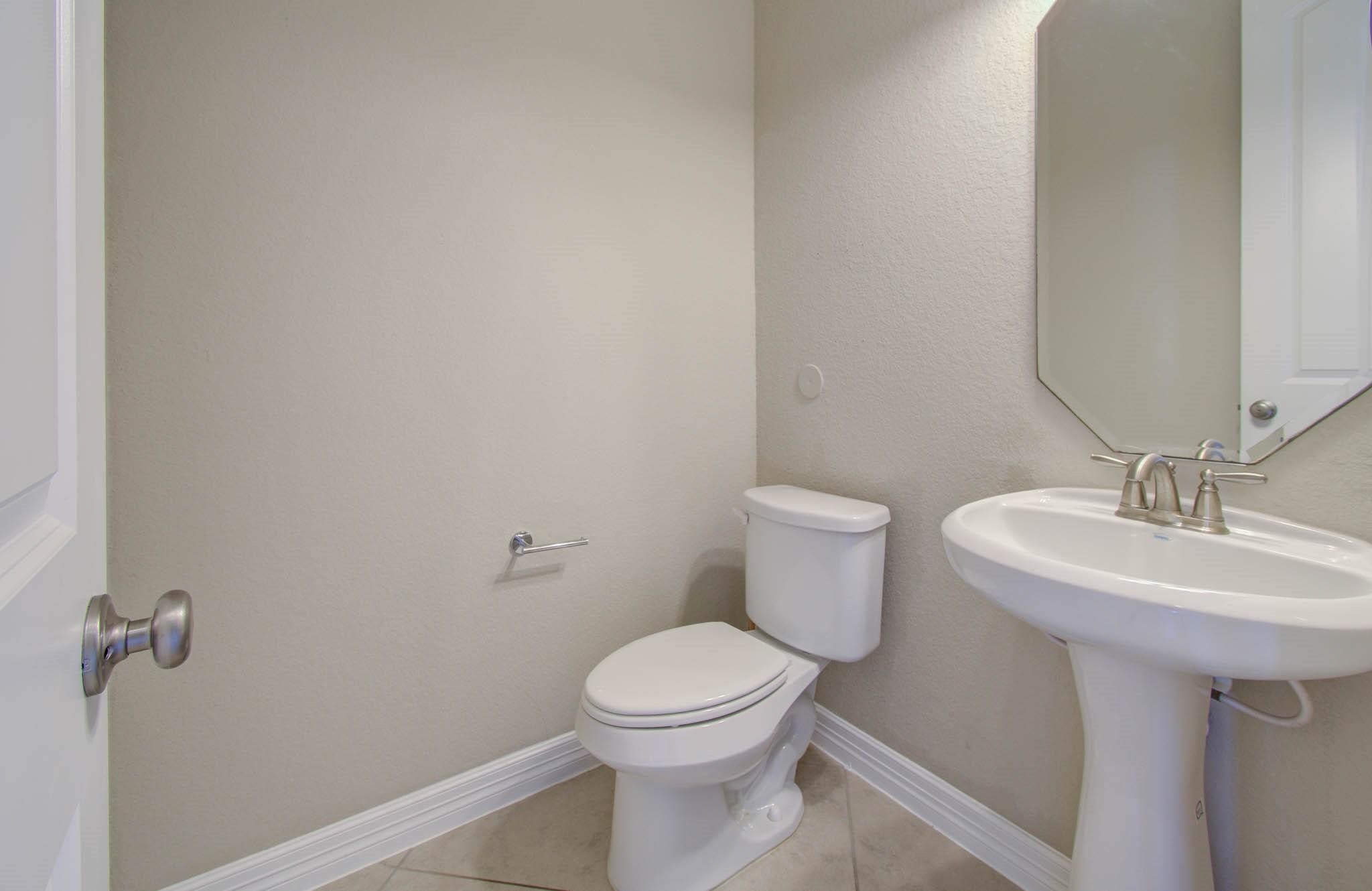 27911 Seger Bnd Trail Spring, TX 77386 - Photo 11 of 49 a bathroom with a sink a toilet and a mirror
