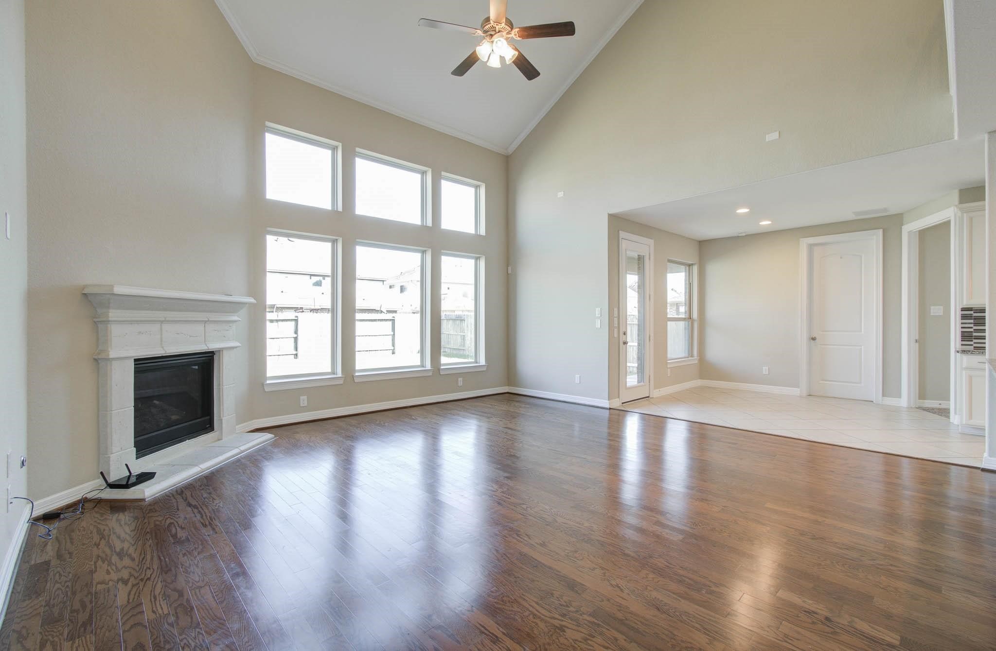 27911 Seger Bnd Trail Spring, TX 77386 - Photo 12 of 49 a view of an empty room with wooden floor fireplace and a window
