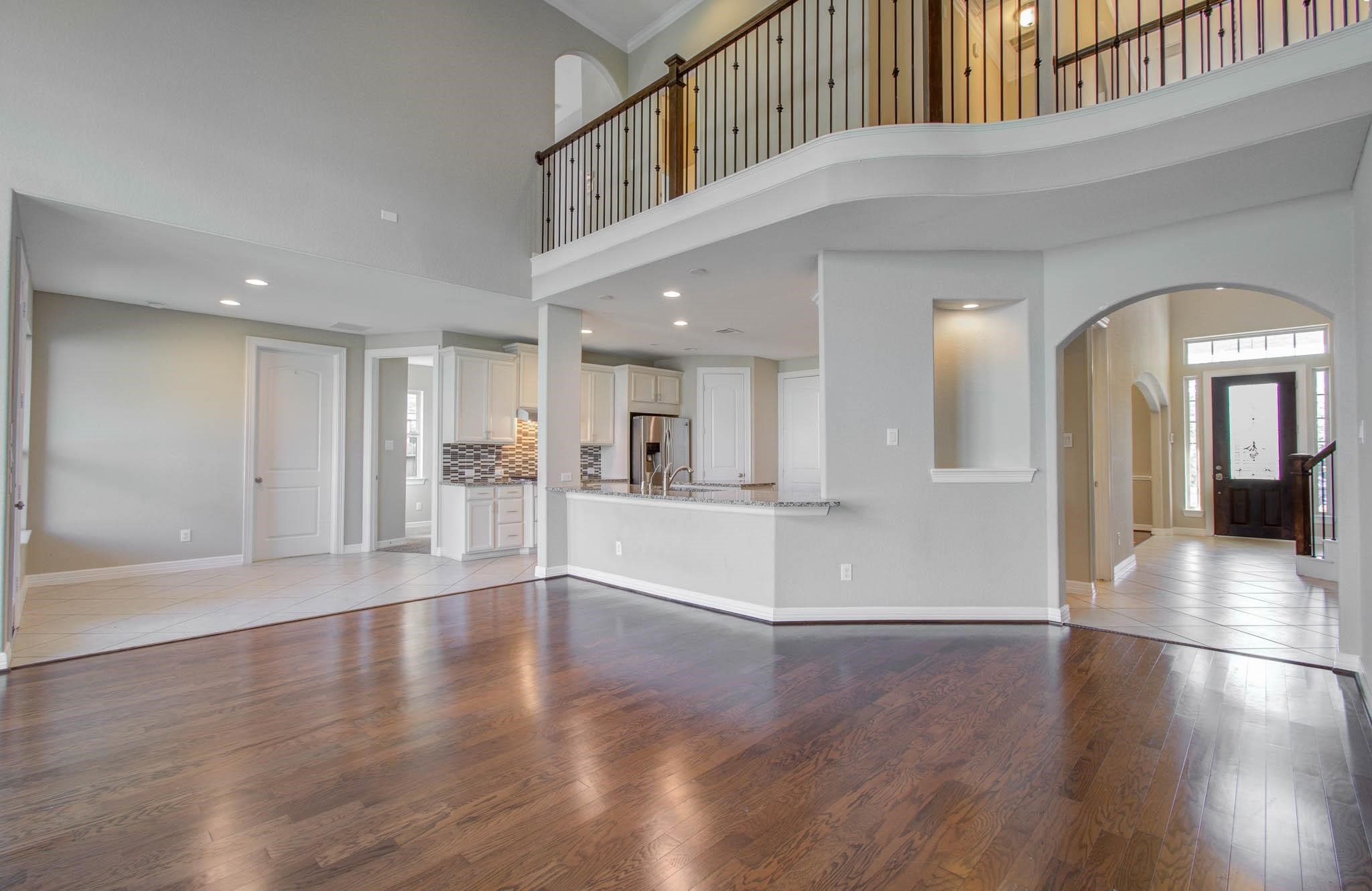27911 Seger Bnd Trail Spring, TX 77386 - Photo 13 of 49 a view of a hallway with wooden floor and a kitchen