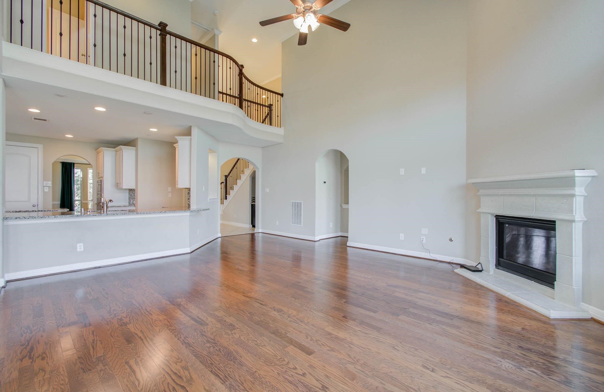 27911 Seger Bnd Trail Spring, TX 77386 - Photo 14 of 49 a view of an empty room with wooden floor and a fireplace