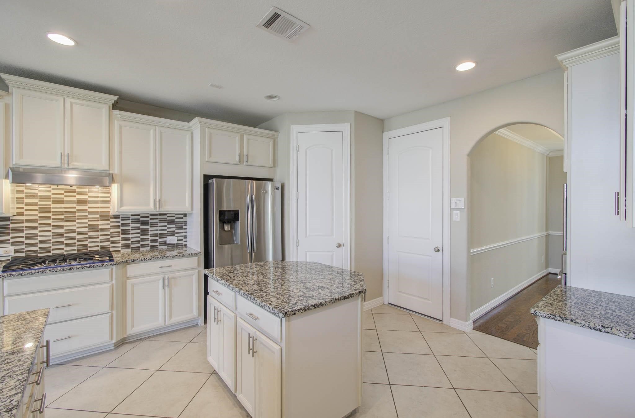 27911 Seger Bnd Trail Spring, TX 77386 - Photo 26 of 49 a kitchen with granite countertop a sink and cabinets